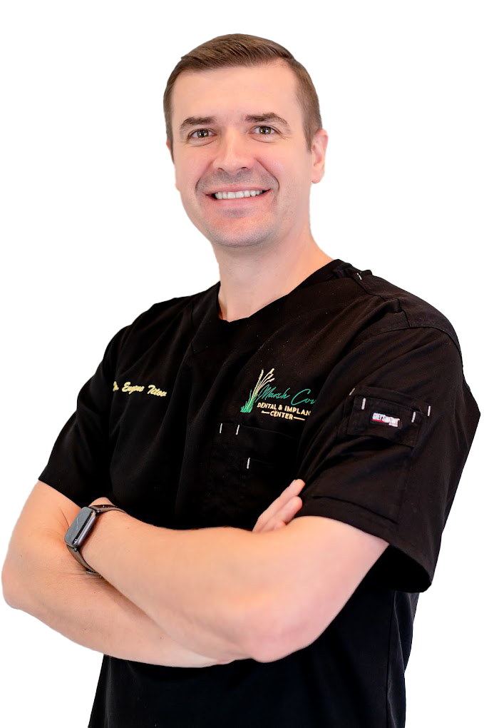 Dr. Eugene Titov, DMD - Professional headshot wearing dark scrubs with Marsh Cove logo